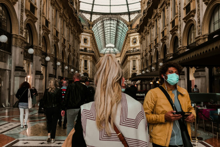 An illustrative photo of an indoor space with a high glass ceiling and ornate architecture.
