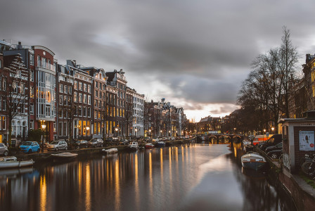 Photo by Unsplash An illustrative photo of a white and brown concrete building near a body of water.
