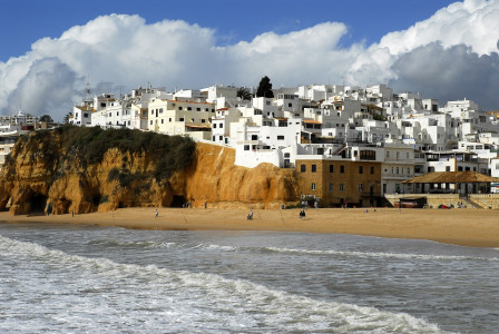 An illustrative photo of a coastal scene with a sandy beach in the foreground.
