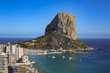 Photo by Pixabay An illustrative photo of a striking rock formation rising prominently from a coastal landscape.