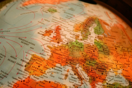 An illustrative photo of a close-up of a globe with Europe in focus