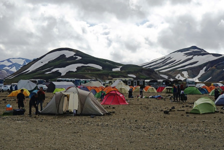 Photo by Pixabay An illustrative photo of a bustling campsite with numerous colorful tents set up on a gravelly terrain