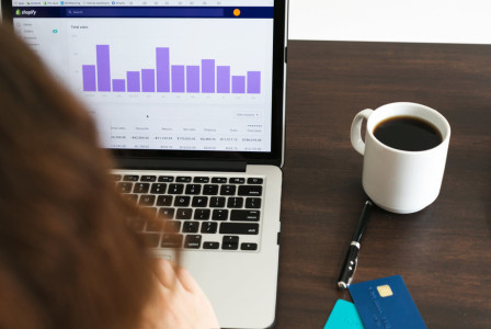 Photo by Shopify An illustrative photo of a person checking data on a laptop