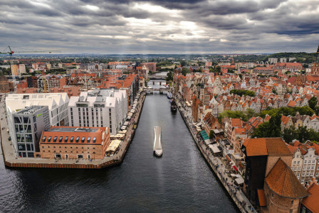An illustrative photo of a city with a river running through it.