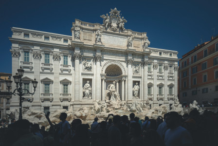 An illustrative photo of people standing in front of building.