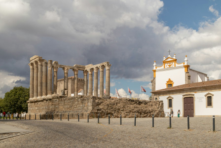 An illustrative photo of a large building with columns and a clock tower