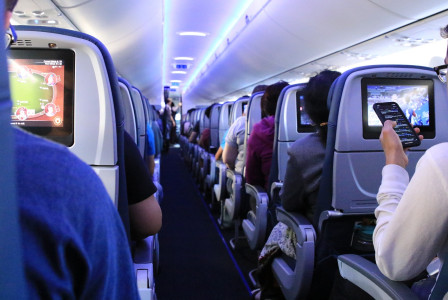 An illustrative photo of an airplane cabin with passengers seated