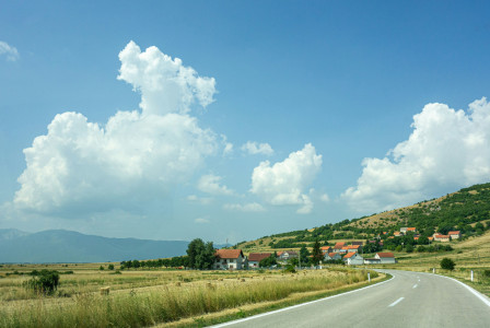 An illustrative photo of a green grass field under blue sky.