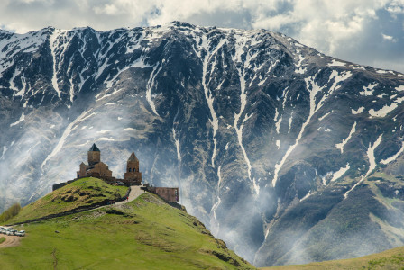 Photo by Unsplash An illustrative photo of a church on a hill with a big snowy mountain in the background.
