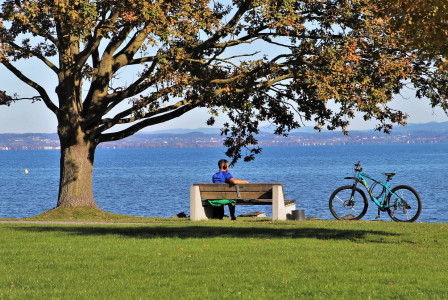 An illustrative photo of a person seated on a bench.
