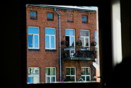 An illustrative photo of a brick building with windows