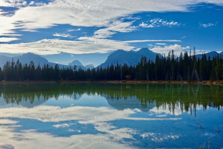 An illustrative photo of a lake reflecting wilderness scenery