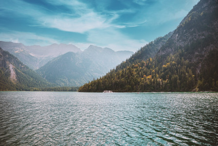 An illustrative photo of a lake and mountains.