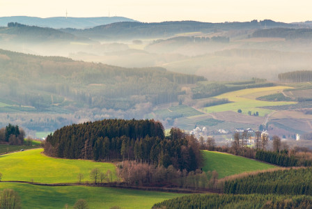 An illustrative photo of a foggy landscape with mountains