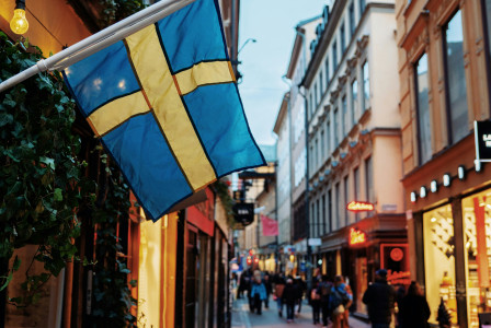 Photo by Unsplash An illustrative photo of people at the street between commercial buildings.