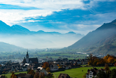 An illustrative photo of houses on field.