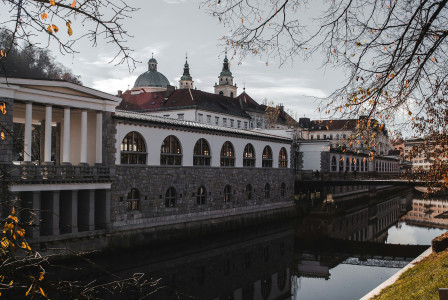 An illustrative photo of a building sitting next to a body of water.