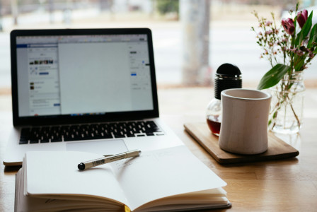 An illustrative photo of a laptop near the window