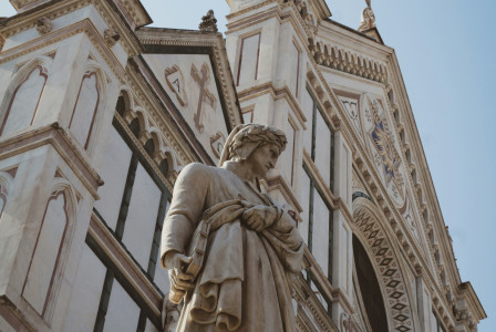 Photo by Unsplash An illustrative photo of a statue of a man holding a book in front of a building