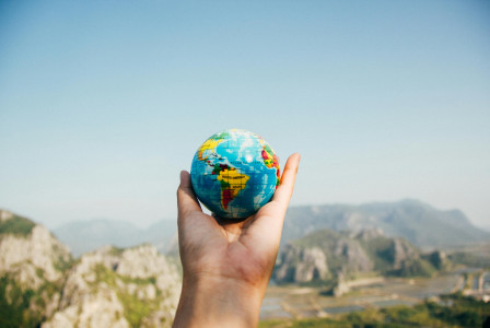 Photo by Pexels An illustrative photo of a person holding world globe.