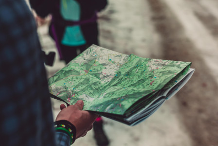An illustrative photo of a person holding an outlined map