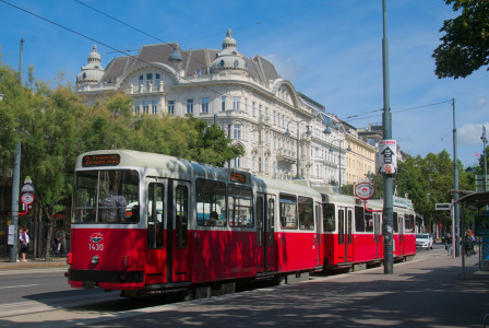 An illustrative photo of a tram driving through street of Vienna, Austria.