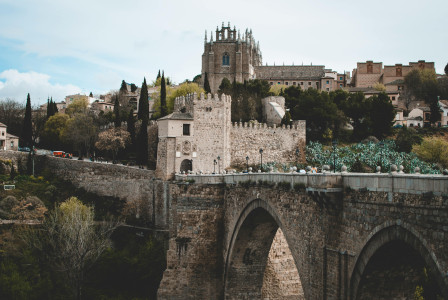 An illustrative photo of gray castle and bridge.