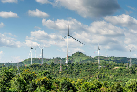 Photo by Pexels An illustrative photo of wind turbines on green grass field under white clouds