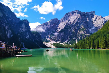 An illustrative photo of a green lake near mountains