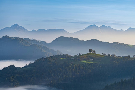 An illustrative photo of a mountain with a house on top of it