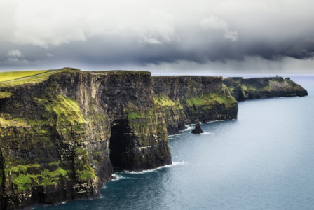 An illustrative photo of a sea and a cliff during daytime