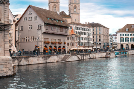 Photo by Unsplash An illustrative photo of a river running through a city next to tall buildings