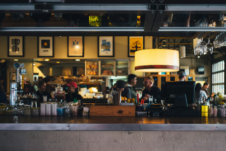 An illustrative photo of a cafe bar counter with people sitting in the background