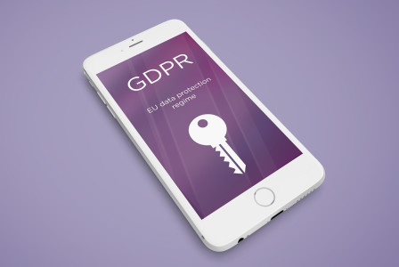 An illustrative photo of a smartphone on a purple surface displaying the acronym “GDPR” with an illustration of a key