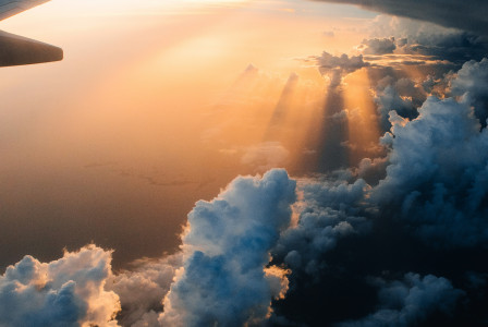 Photo by Unsplash An illustrative photo of a plane in the sky in the light of sunset