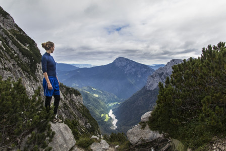 An illustrative photo of an individual standing on a rocky outcrop.