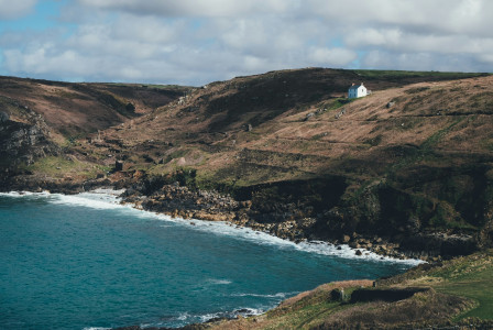 An illustrative photo of a mountain near body of water.