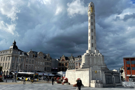 An illustrative photo of a tall white tower in the city in Belgium