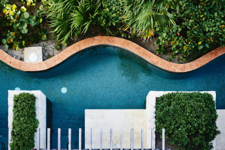 Photo by Unsplash An illustrative photo of a swimming pool near a white concrete building