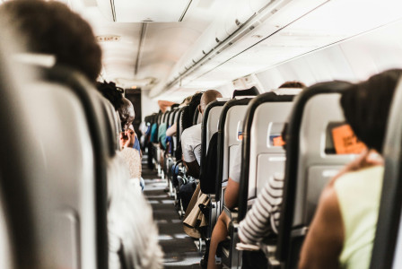 An illustrative photo of people sitting in a airplane