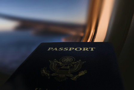 An illustrative photo of a passport in the airplane during a flight 