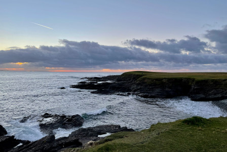 An illustrative photo of a lighthouse on a cliff.