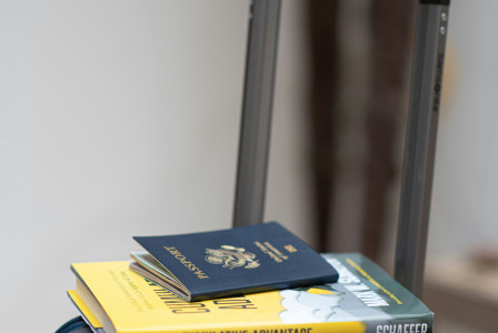 Photo by Unsplash An illustrative photo of a suitcase with a book and a passport on top