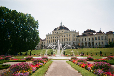 An illustrative photo of a palace near green field and park
