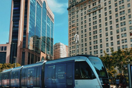 An illustrative photo of a train in the city with tall buildings in the background