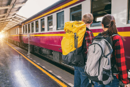 An illustrative photo of a woman and a man waiting on train station