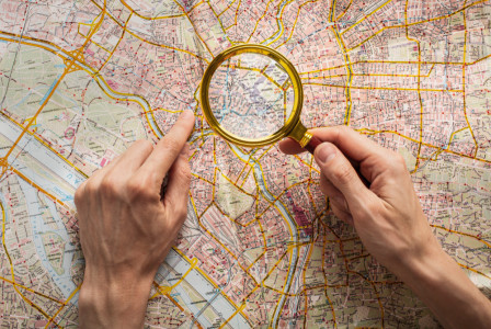 Top view hands holding magnifying glass