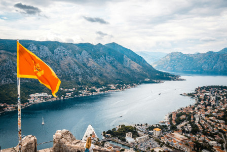An illustrative photo of a view of a lake and mountains from a castle
