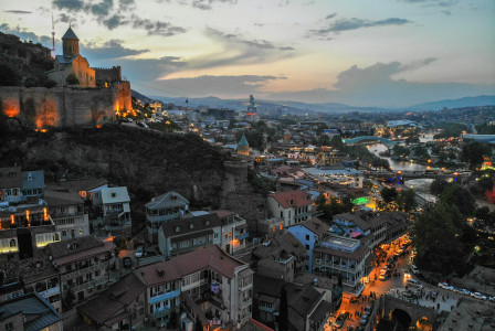 An illustrative photo of a view of Tbilisi during the evening
