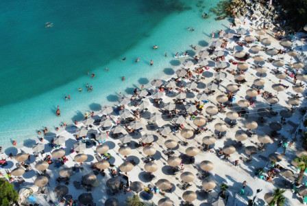 Photo by Unsplash An illustrative photo of a beach with umbrellas full of people